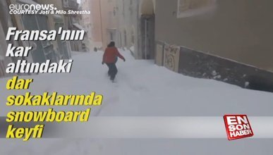 Fransa'nın kar altındaki dar sokaklarında snowboard keyfi