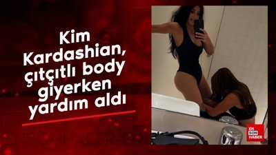 Kim Kardashian, çıtçıtlı body giyerken yardım aldı
