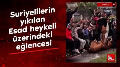 Suriyelilerin yıkılan Esad heykeli üzerindeki eğlencesi