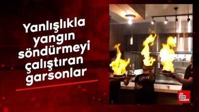 Yanlışlıkla yangın söndürmeyi çalıştıran garsonlar